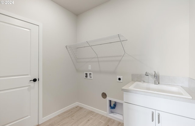 laundry area with cabinets, washer hookup, electric dryer hookup, sink, and light hardwood / wood-style floors