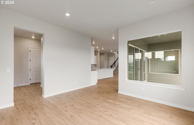 unfurnished room with light wood-style flooring and baseboards