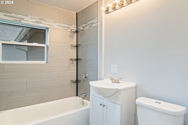 full bathroom with vanity, toilet, and tiled shower / bath combo