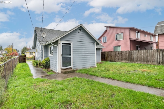 rear view of house with a lawn