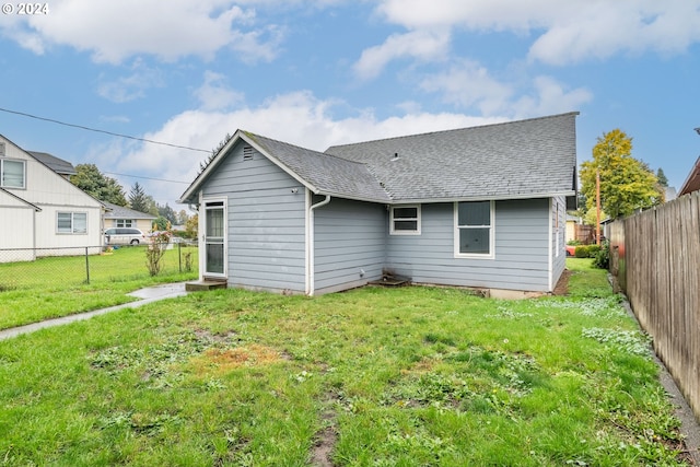 rear view of house with a lawn