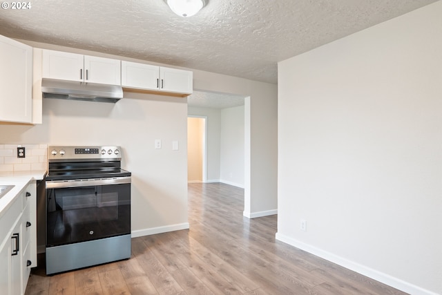 kitchen featuring white cabinets, stainless steel electric range, and light wood-type flooring