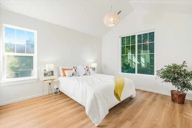 bedroom featuring vaulted ceiling and light hardwood / wood-style flooring