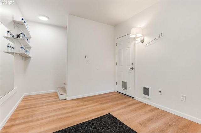 interior space with wood-type flooring and heating unit