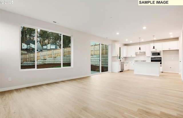 unfurnished living room featuring light wood-type flooring