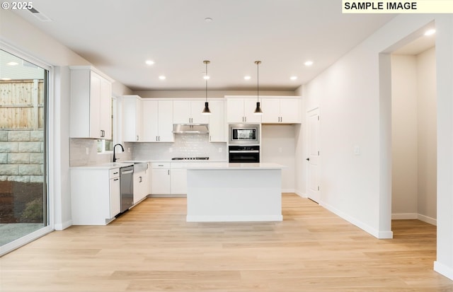 kitchen featuring white cabinetry, a kitchen island, and black appliances