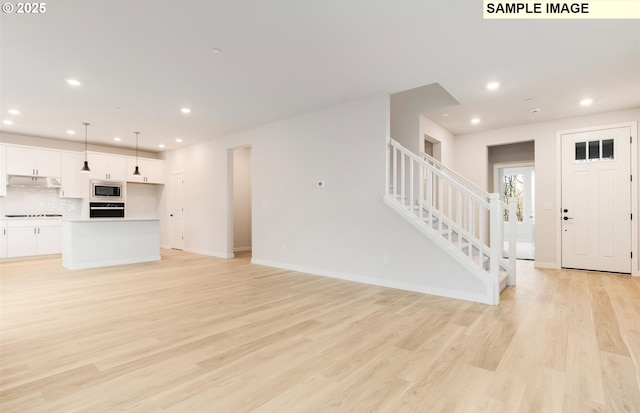 unfurnished living room with light hardwood / wood-style floors