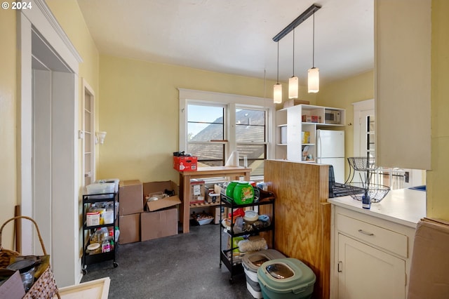 kitchen with pendant lighting and white refrigerator