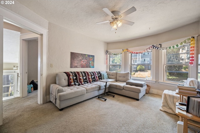 carpeted living room with a textured ceiling and ceiling fan