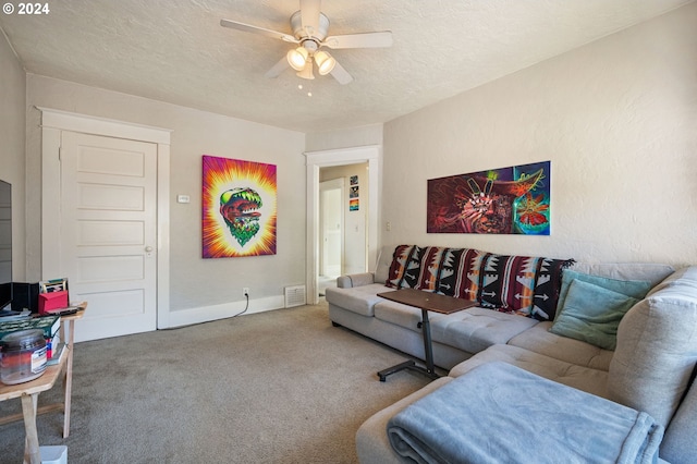 carpeted living room featuring a textured ceiling and ceiling fan