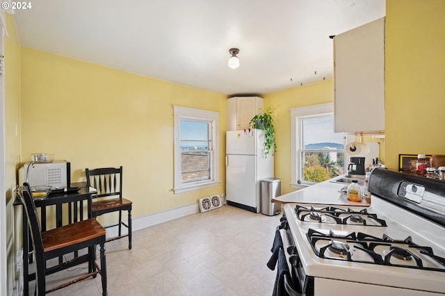 kitchen with white cabinets and white appliances