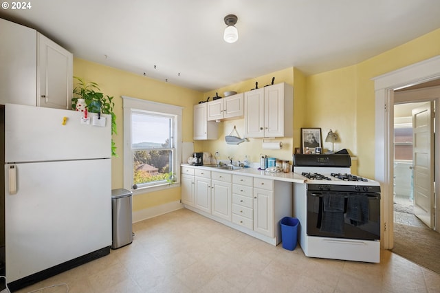 kitchen featuring white cabinetry, sink, and white appliances