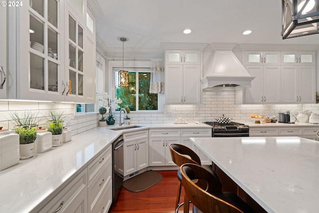 kitchen featuring sink, hanging light fixtures, black range with gas cooktop, custom exhaust hood, and ornamental molding