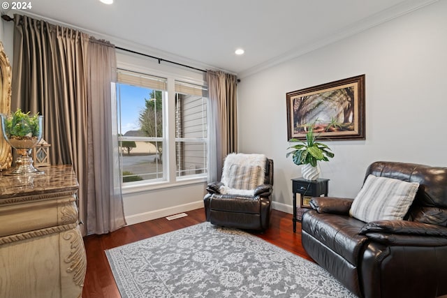 living area featuring dark hardwood / wood-style flooring and ornamental molding