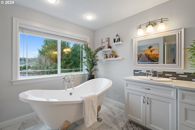 bathroom featuring a washtub, backsplash, and vanity