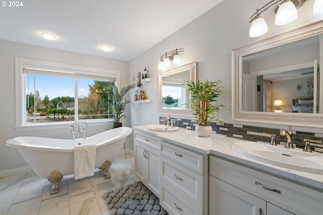 bathroom with vanity, a bath, and backsplash