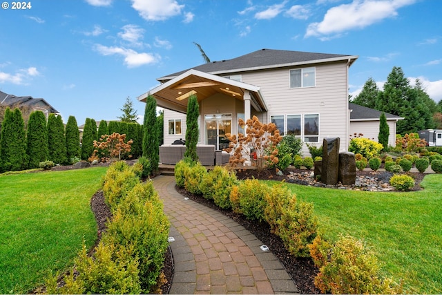 back of house featuring a lawn and an outdoor hangout area