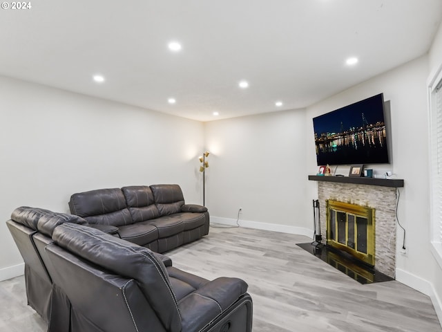 living room featuring a fireplace and light hardwood / wood-style floors