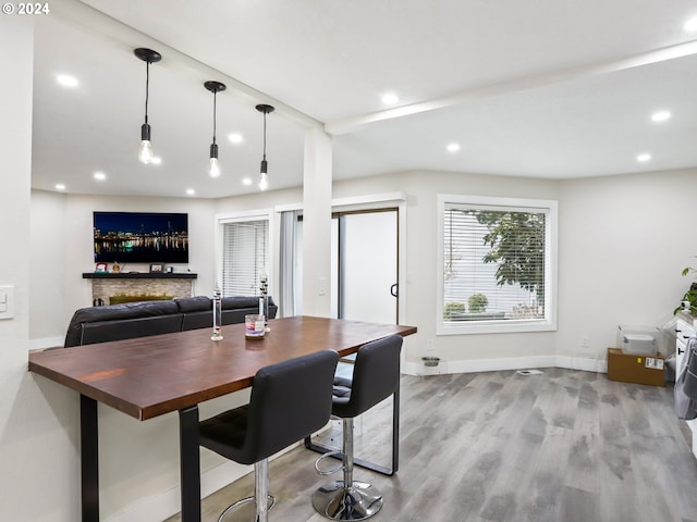 interior space featuring a stone fireplace and light wood-type flooring