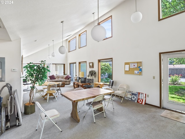 dining area with plenty of natural light, high vaulted ceiling, and light colored carpet