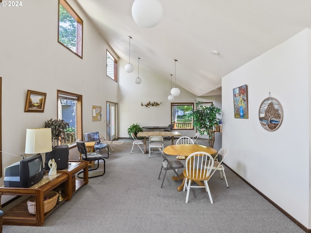 dining space featuring high vaulted ceiling and carpet floors