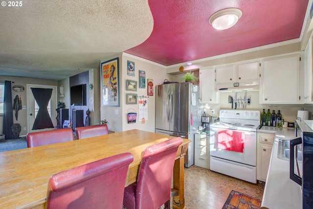 kitchen featuring white cabinets, stainless steel fridge, a textured ceiling, and white range with electric cooktop