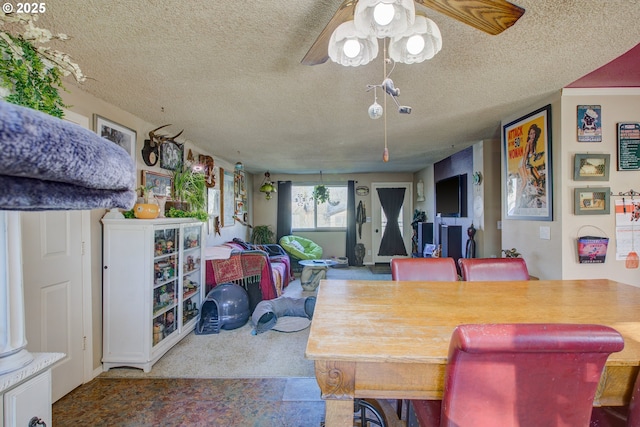 dining room featuring ceiling fan and a textured ceiling