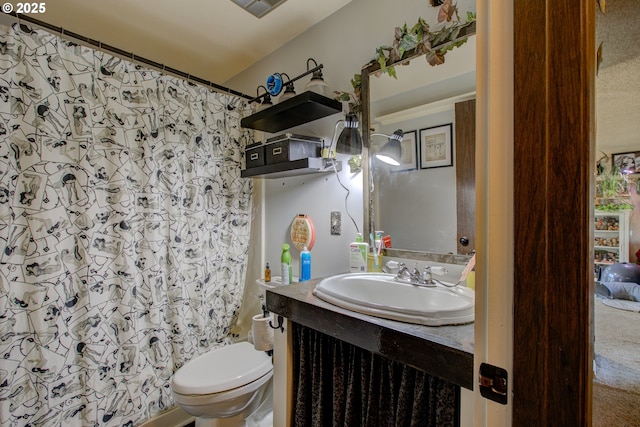 bathroom featuring vanity, a shower with shower curtain, and toilet