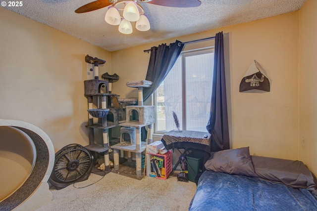 carpeted bedroom with multiple windows, a textured ceiling, and ceiling fan