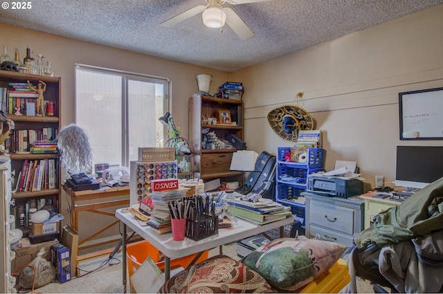 carpeted office featuring ceiling fan and a textured ceiling