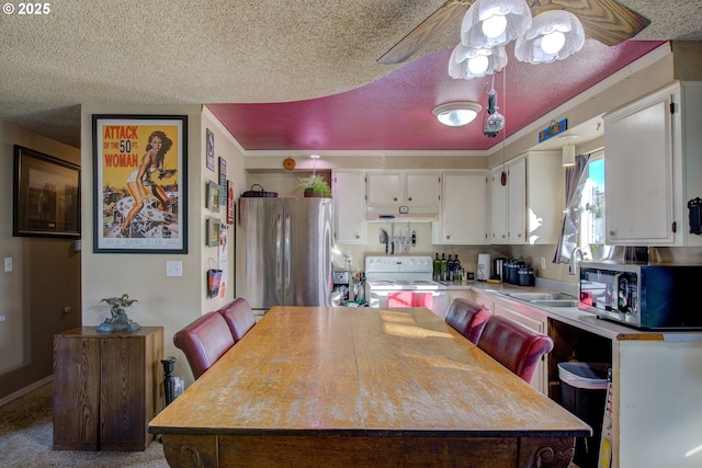 kitchen featuring a kitchen island, white cabinetry, appliances with stainless steel finishes, and sink