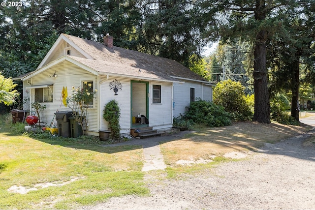 view of outdoor structure featuring a lawn