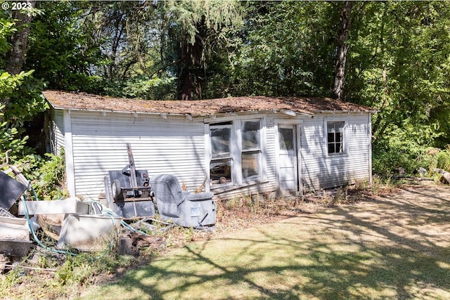 view of outbuilding with a yard