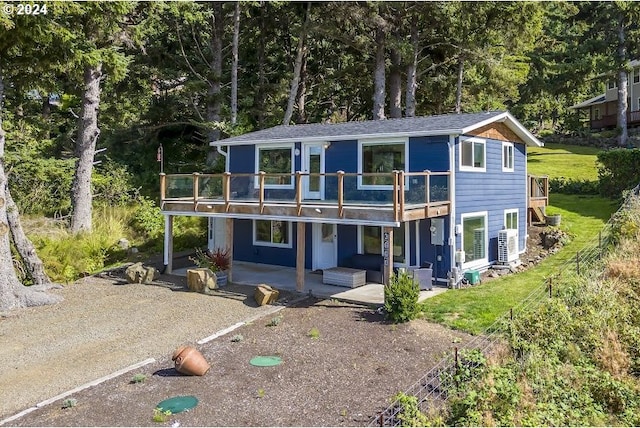 exterior space with a balcony, a patio, an outdoor living space, and central AC unit