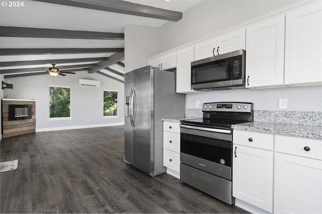 3660 Rocky Creek Ave, Depoe Bay, OR 97341 - kitchen with stainless steel appliances, a wall mounted AC, dark wood-style floors, a ceiling fan, and white cabinetry