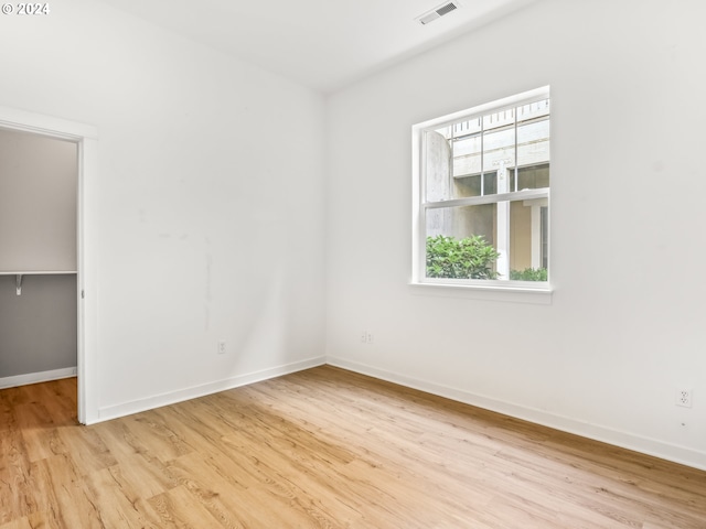 unfurnished room with light hardwood / wood-style flooring