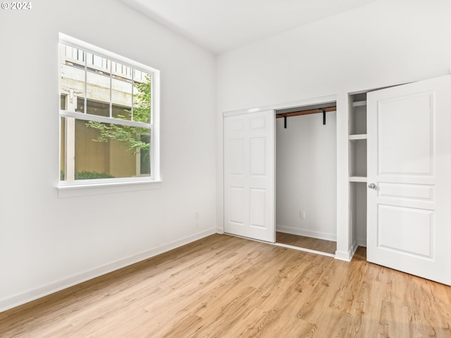 unfurnished bedroom with light wood-type flooring