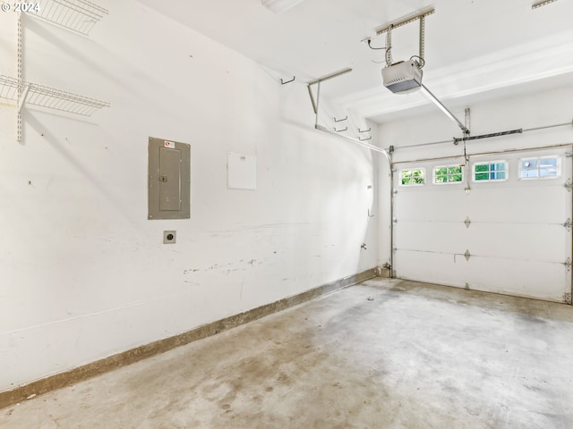 garage featuring electric panel and a garage door opener