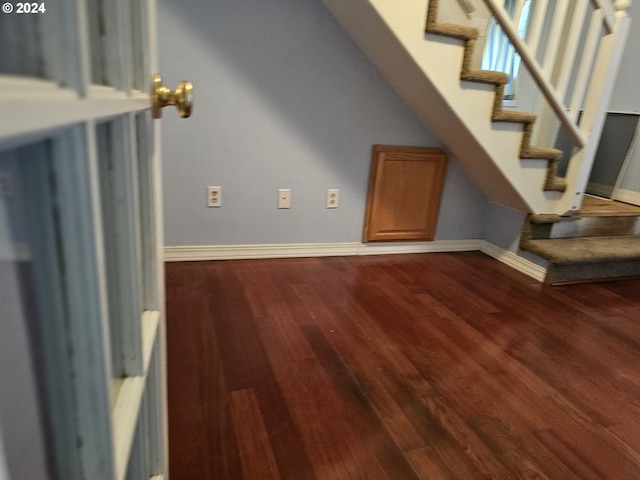 unfurnished living room featuring dark hardwood / wood-style floors