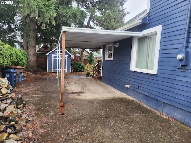 view of patio with a carport and a storage shed