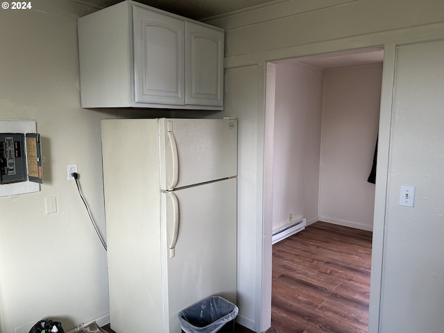 kitchen featuring dark hardwood / wood-style flooring, white refrigerator, a baseboard radiator, electric panel, and white cabinetry