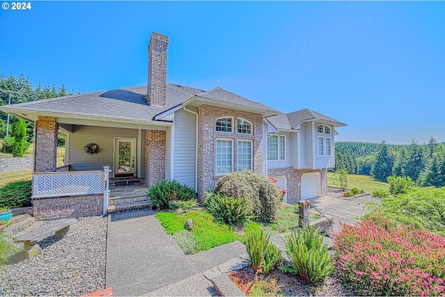 view of front of home featuring a garage and a porch