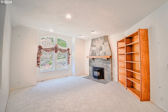 unfurnished living room featuring carpet floors and a textured ceiling