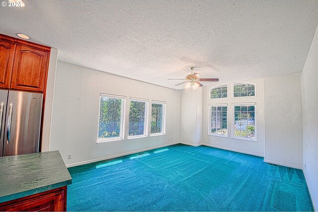 interior space featuring ceiling fan and a textured ceiling