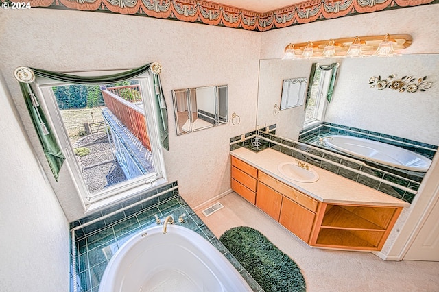 bathroom featuring vanity and tiled bath