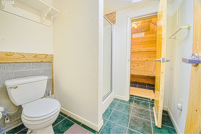 bathroom with toilet, an enclosed shower, and tile patterned flooring