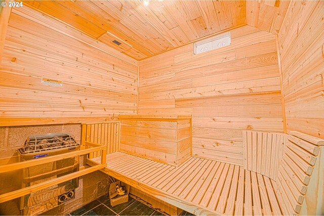 view of sauna featuring wood ceiling and wooden walls