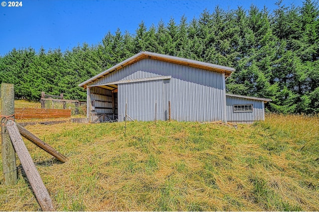 view of outdoor structure featuring a lawn