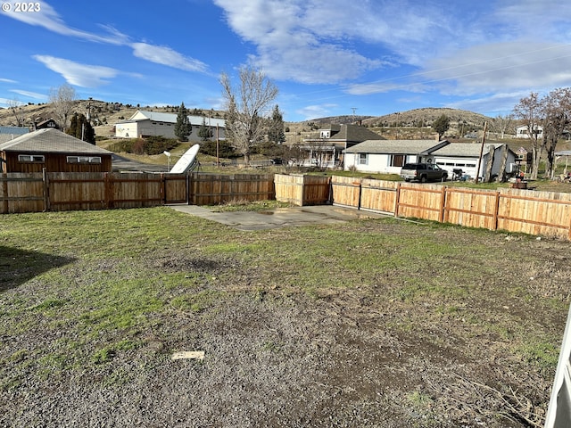 view of yard with a mountain view and a patio area