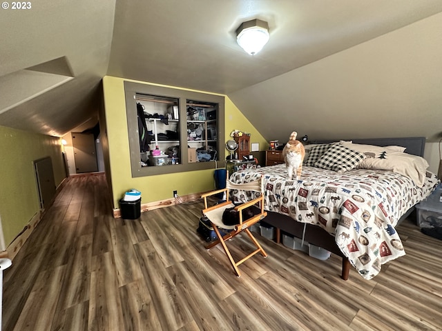 bedroom featuring lofted ceiling and hardwood / wood-style floors